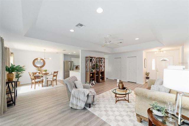 2644 SW 20th Cir, Ocala, FL 34471 - living room featuring a raised ceiling, light wood-style flooring, baseboards, ceiling fan, and recessed lighting