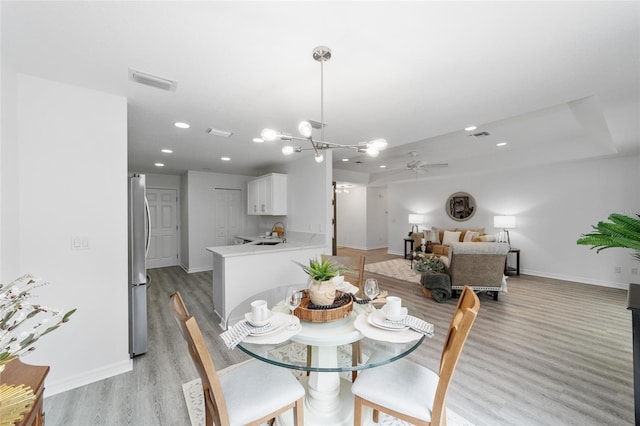 2644 SW 20th Cir, Ocala, FL 34471 - dining space featuring baseboards, light wood-style flooring, recessed lighting, a ceiling fan, and a chandelier