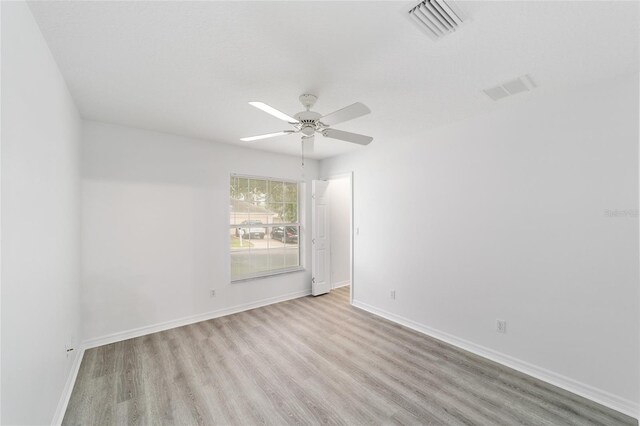 2644 SW 20th Cir, Ocala, FL 34471 - spare room featuring wood finished floors, a ceiling fan, and baseboards