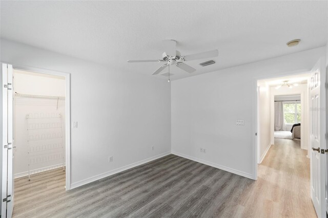 2644 SW 20th Cir, Ocala, FL 34471 - spare room with a ceiling fan, wood finished floors, and baseboards