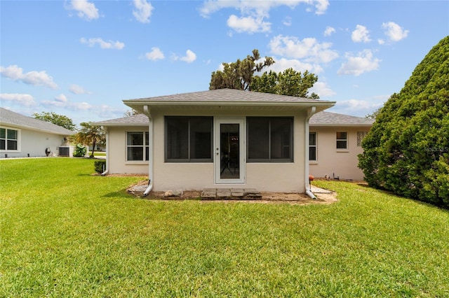 2644 SW 20th Cir, Ocala, FL 34471 - back of property featuring a yard, a sunroom, and stucco siding