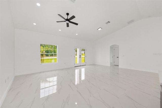 8456 SE 164th Pl, Summerfield, FL 34491 - unfurnished room featuring arched walkways, ceiling fan, vaulted ceiling, light marble finish flooring, and baseboards