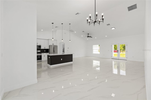 8456 SE 164th Pl, Summerfield, FL 34491 - unfurnished living room featuring light marble finish flooring, high vaulted ceiling, baseboards, a chandelier, and a ceiling fan