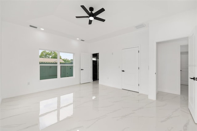 8456 SE 164th Pl, Summerfield, FL 34491 - spare room featuring ceiling fan, light marble finish flooring, baseboards, a raised ceiling, and recessed lighting