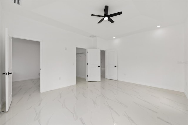 8456 SE 164th Pl, Summerfield, FL 34491 - unfurnished bedroom with baseboards, recessed lighting, a spacious closet, light marble finish floors, and ceiling fan