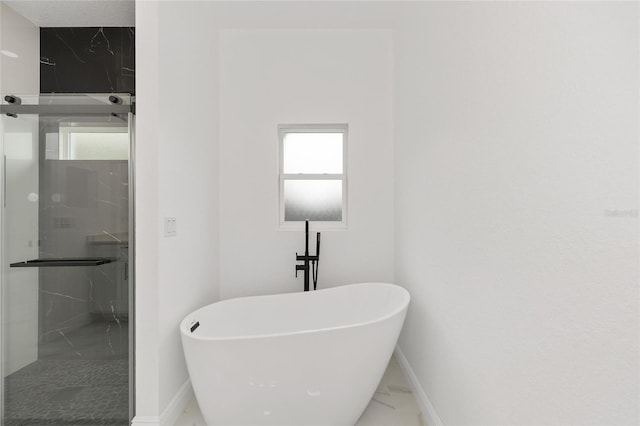 8456 SE 164th Pl, Summerfield, FL 34491 - bathroom with marble finish flooring, baseboards, a soaking tub, and a marble finish shower