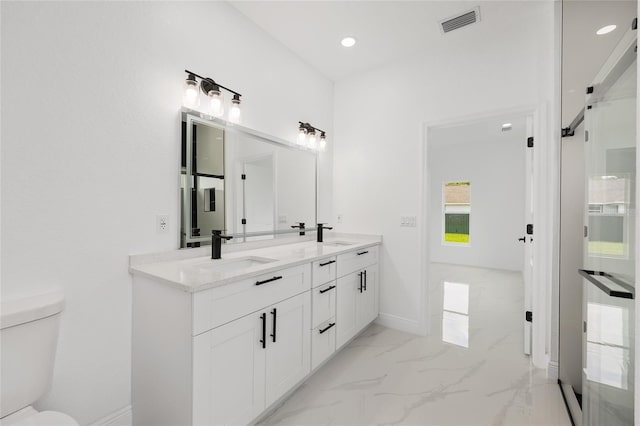 8456 SE 164th Pl, Summerfield, FL 34491 - full bath with double vanity, marble finish floors, toilet, recessed lighting, and baseboards
