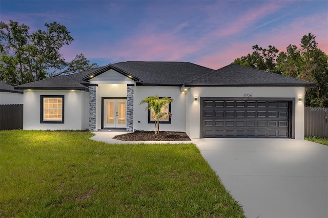 8456 SE 164th Pl, Summerfield, FL 34491 - view of front facade with french doors, a garage, driveway, and stucco siding