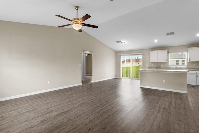 17277 SW 44th Cir, Ocala, FL 34473 - unfurnished living room featuring a ceiling fan, vaulted ceiling, dark wood-type flooring, baseboards, and recessed lighting
