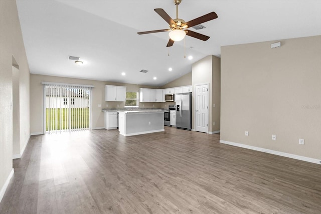 17277 SW 44th Cir, Ocala, FL 34473 - unfurnished living room featuring vaulted ceiling, ceiling fan, wood finished floors, baseboards, and recessed lighting