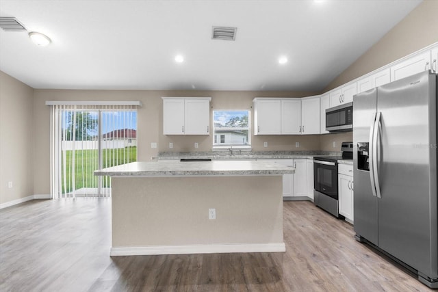 17277 SW 44th Cir, Ocala, FL 34473 - kitchen featuring stainless steel appliances, a center island, plenty of natural light, white cabinetry, and recessed lighting