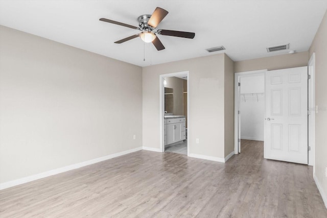 17277 SW 44th Cir, Ocala, FL 34473 - unfurnished bedroom with light wood-type flooring, a walk in closet, baseboards, and a closet