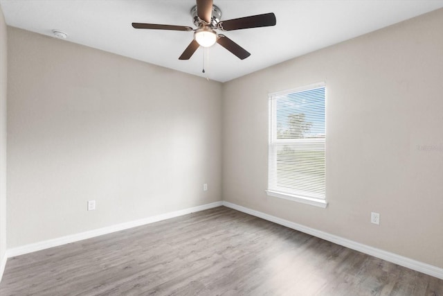17277 SW 44th Cir, Ocala, FL 34473 - empty room featuring wood finished floors, baseboards, ceiling fan, and a smoke detector