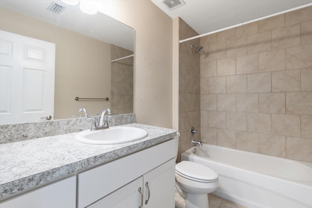17277 SW 44th Cir, Ocala, FL 34473 - full bathroom featuring vanity, toilet, bathtub / shower combination, a textured wall, and tile patterned flooring
