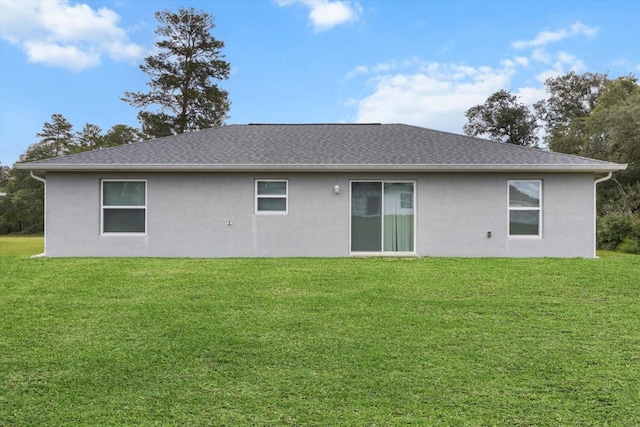 17277 SW 44th Cir, Ocala, FL 34473 - rear view of house featuring stucco siding and a lawn