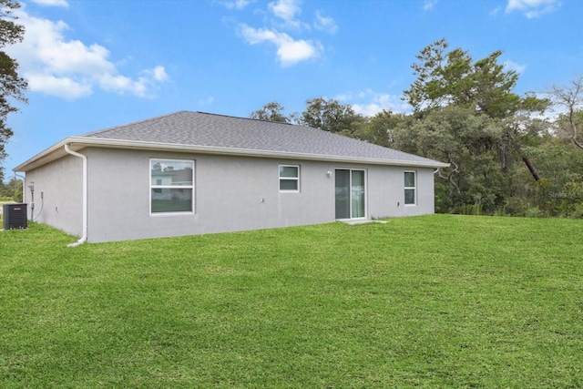 17277 SW 44th Cir, Ocala, FL 34473 - rear view of house with a yard, central AC, and stucco siding