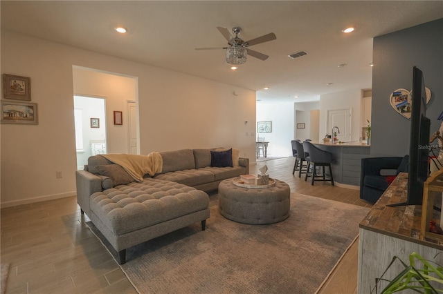 19551 SW 77th Loop, Dunnellon, FL 34432 - living area featuring ceiling fan, light wood finished floors, recessed lighting, and baseboards