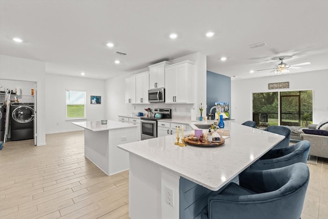 19551 SW 77th Loop, Dunnellon, FL 34432 - kitchen featuring appliances with stainless steel finishes, open floor plan, a center island, healthy amount of natural light, and recessed lighting