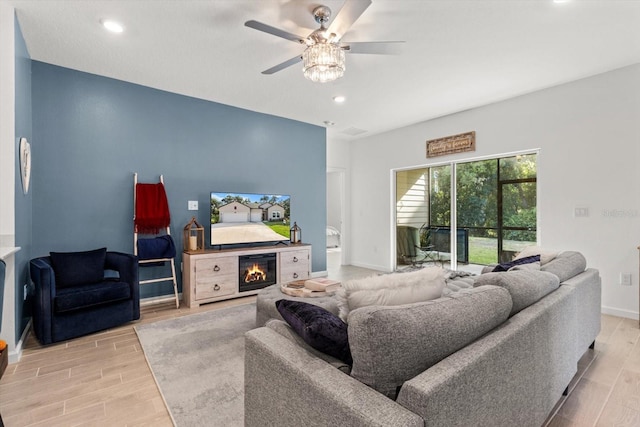 19551 SW 77th Loop, Dunnellon, FL 34432 - living room featuring wood finished floors, ceiling fan, recessed lighting, and a glass covered fireplace