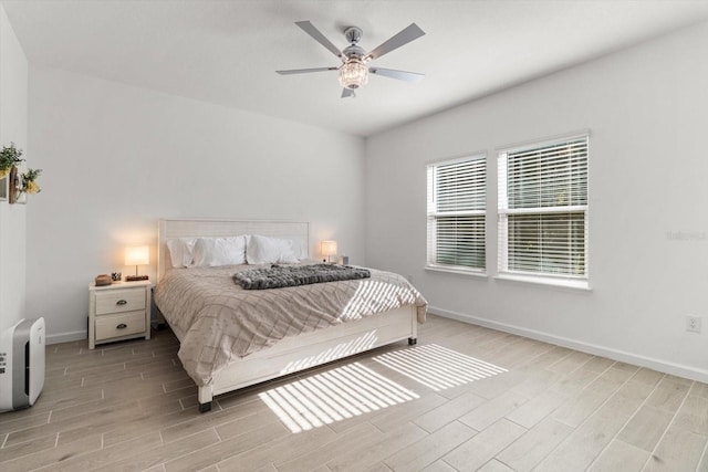 19551 SW 77th Loop, Dunnellon, FL 34432 - bedroom with light wood finished floors and a ceiling fan