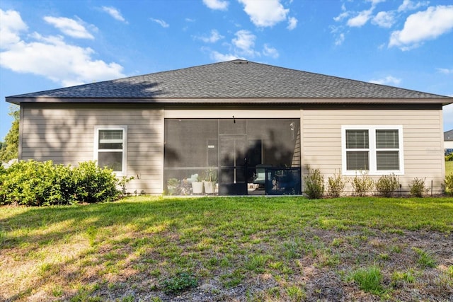 19551 SW 77th Loop, Dunnellon, FL 34432 - back of house with a yard, a sunroom, and roof with shingles