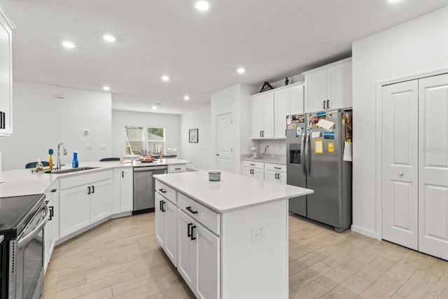 19551 SW 77th Loop, Dunnellon, FL 34432 - kitchen featuring appliances with stainless steel finishes, light wood-type flooring, a center island, light countertops, and recessed lighting
