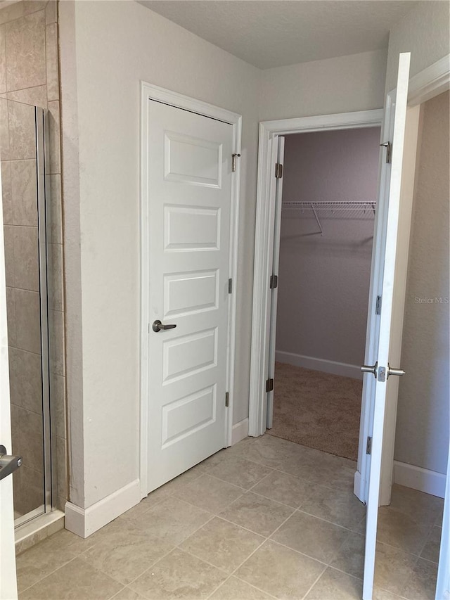 2 Pine Course Trl, Ocala, FL 34472 - full bathroom with a stall shower, a spacious closet, tile patterned floors, and baseboards