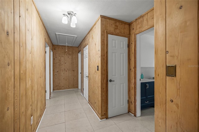 3331 SE 4th St, Ocala, FL 34471 - corridor featuring attic access, light tile patterned floors, baseboards, and wood walls