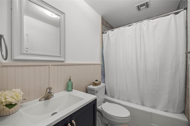 3331 SE 4th St, Ocala, FL 34471 - bathroom with toilet, shower / tub combo with curtain, vanity, and wainscoting