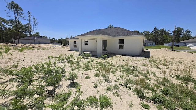 717 Marion Oaks Mnr, Ocala, FL 34473 - rear view of property with stucco siding and a patio area