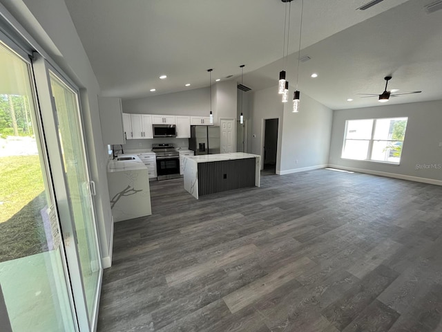 717 Marion Oaks Mnr, Ocala, FL 34473 - kitchen with stainless steel appliances, vaulted ceiling, recessed lighting, a center island, and open floor plan