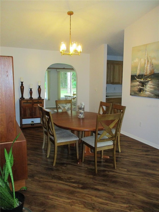 14192 SW 112th Cir, Dunnellon, FL 34432 - dining space with dark wood-style flooring, arched walkways, a chandelier, and baseboards