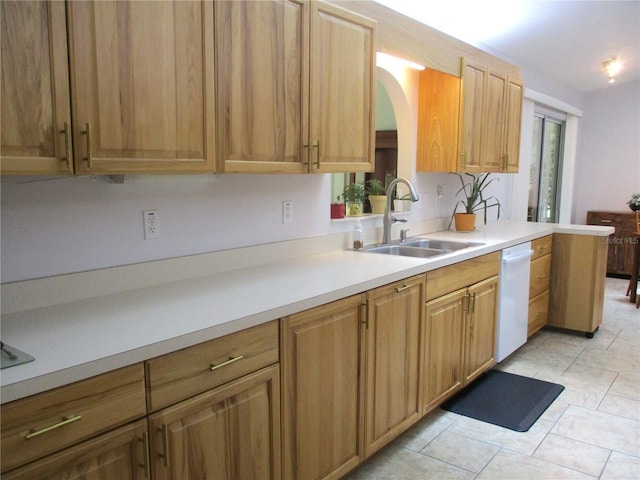 14192 SW 112th Cir, Dunnellon, FL 34432 - kitchen with a sink, dishwasher, light countertops, arched walkways, and light tile patterned floors