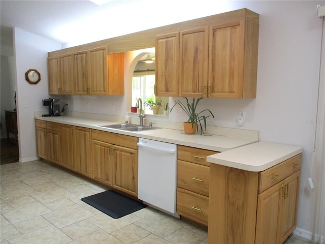 14192 SW 112th Cir, Dunnellon, FL 34432 - kitchen with white dishwasher, a sink, light countertops, arched walkways, and light tile patterned floors