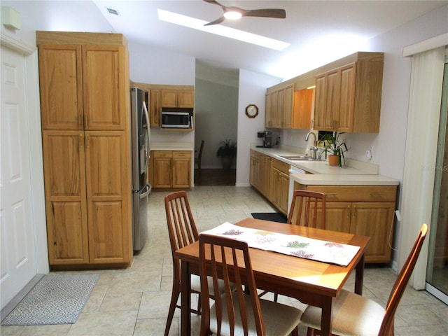 14192 SW 112th Cir, Dunnellon, FL 34432 - kitchen with appliances with stainless steel finishes, a skylight, a sink, lofted ceiling, and a ceiling fan