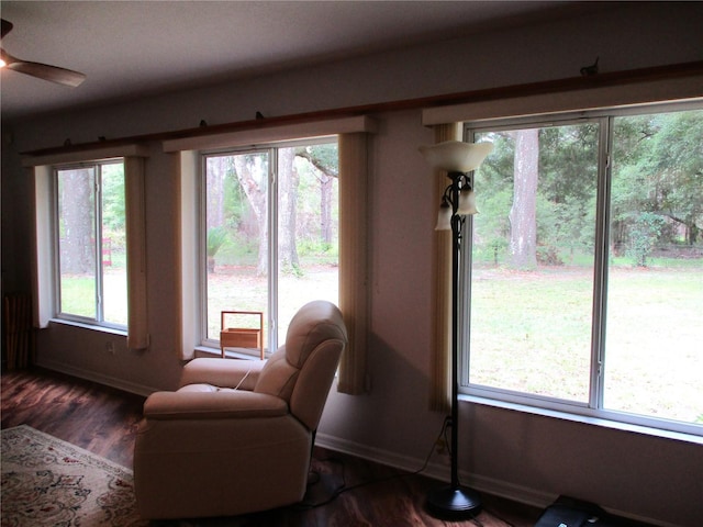14192 SW 112th Cir, Dunnellon, FL 34432 - sitting room with baseboards, dark wood-style floors, and ceiling fan