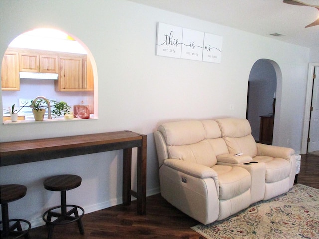 14192 SW 112th Cir, Dunnellon, FL 34432 - sitting room with dark wood-style floors, arched walkways, and ceiling fan