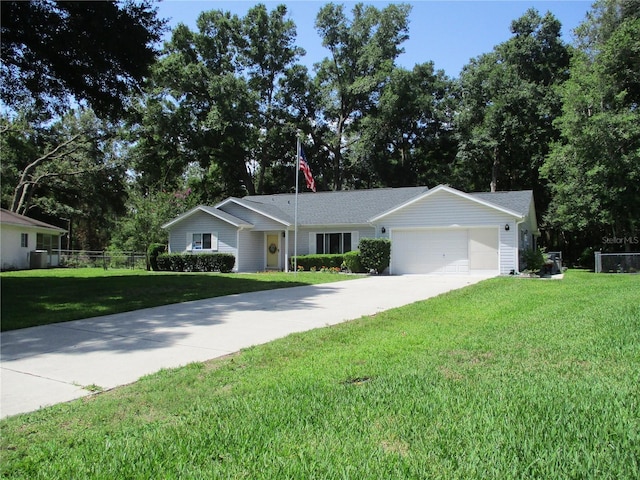 14192 SW 112th Cir, Dunnellon, FL 34432 - ranch-style home with driveway, a garage, and view of wooded area