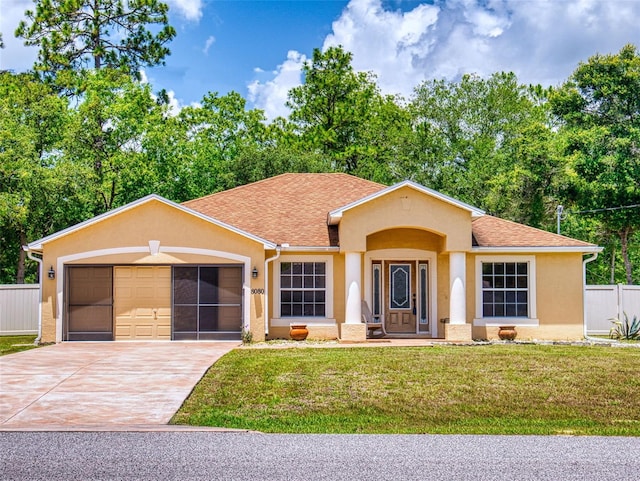 8080 N Susan Ave, Dunnellon, FL 34433 - view of front of home with stucco siding, a garage, concrete driveway, and roof with shingles