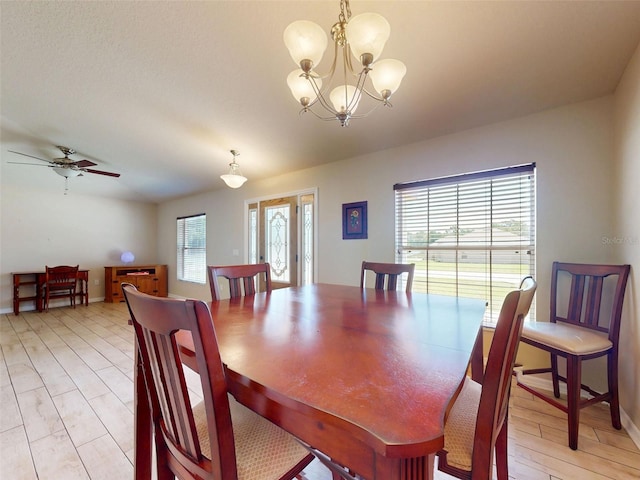 8080 N Susan Ave, Dunnellon, FL 34433 - dining room featuring a chandelier, a ceiling fan, and light wood-style flooring