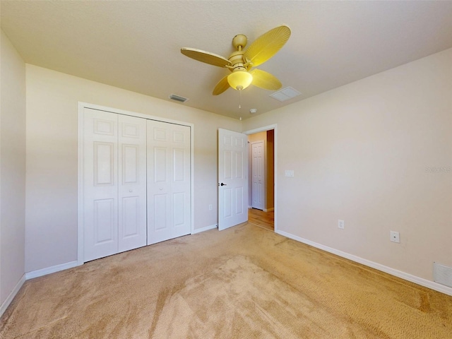 8080 N Susan Ave, Dunnellon, FL 34433 - unfurnished bedroom featuring light carpet, a closet, and a ceiling fan