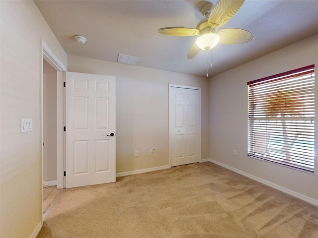 8080 N Susan Ave, Dunnellon, FL 34433 - unfurnished bedroom with light colored carpet, a closet, and a ceiling fan