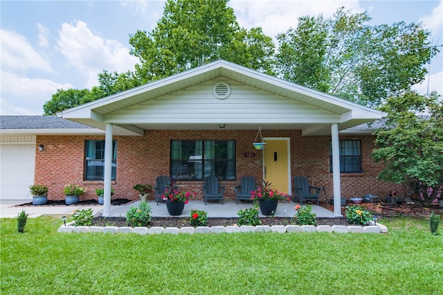 126 SW Mockingbird Way, Lake City, FL 32024 - view of front of property featuring a front lawn, a porch, an attached garage, and brick siding