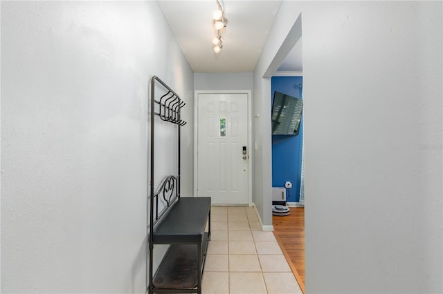 126 SW Mockingbird Way, Lake City, FL 32024 - doorway to outside with light tile patterned floors, baseboards, and track lighting