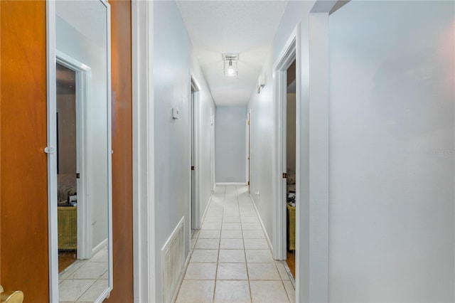 126 SW Mockingbird Way, Lake City, FL 32024 - hallway featuring light tile patterned floors and baseboards