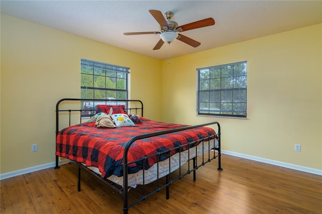 126 SW Mockingbird Way, Lake City, FL 32024 - bedroom with baseboards, multiple windows, and wood finished floors