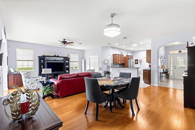 9551 SW 92nd Ter, Ocala, FL 34481 - dining space featuring healthy amount of natural light, a ceiling fan, arched walkways, light wood-style floors, and a textured ceiling