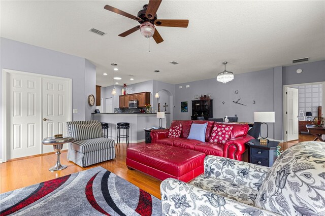 9551 SW 92nd Ter, Ocala, FL 34481 - living area featuring ceiling fan, light wood finished floors, arched walkways, and baseboards