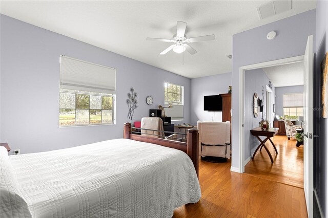9551 SW 92nd Ter, Ocala, FL 34481 - bedroom with light wood finished floors, a ceiling fan, and baseboards