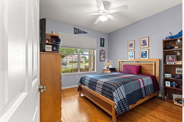 9551 SW 92nd Ter, Ocala, FL 34481 - bedroom with wood finished floors, baseboards, and a ceiling fan
